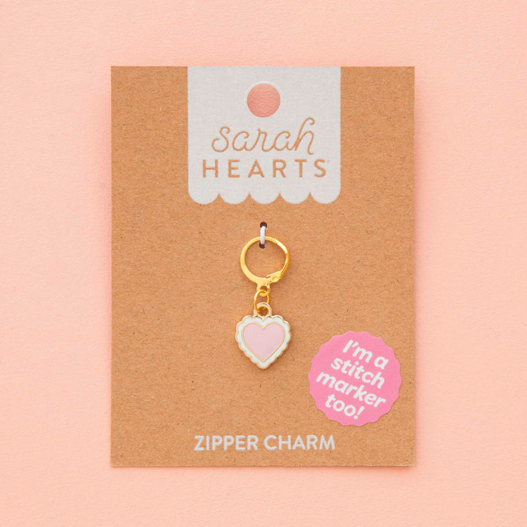 Heart-shaped zipper charm on a 'Sarah Hearts' branded card with a pink background